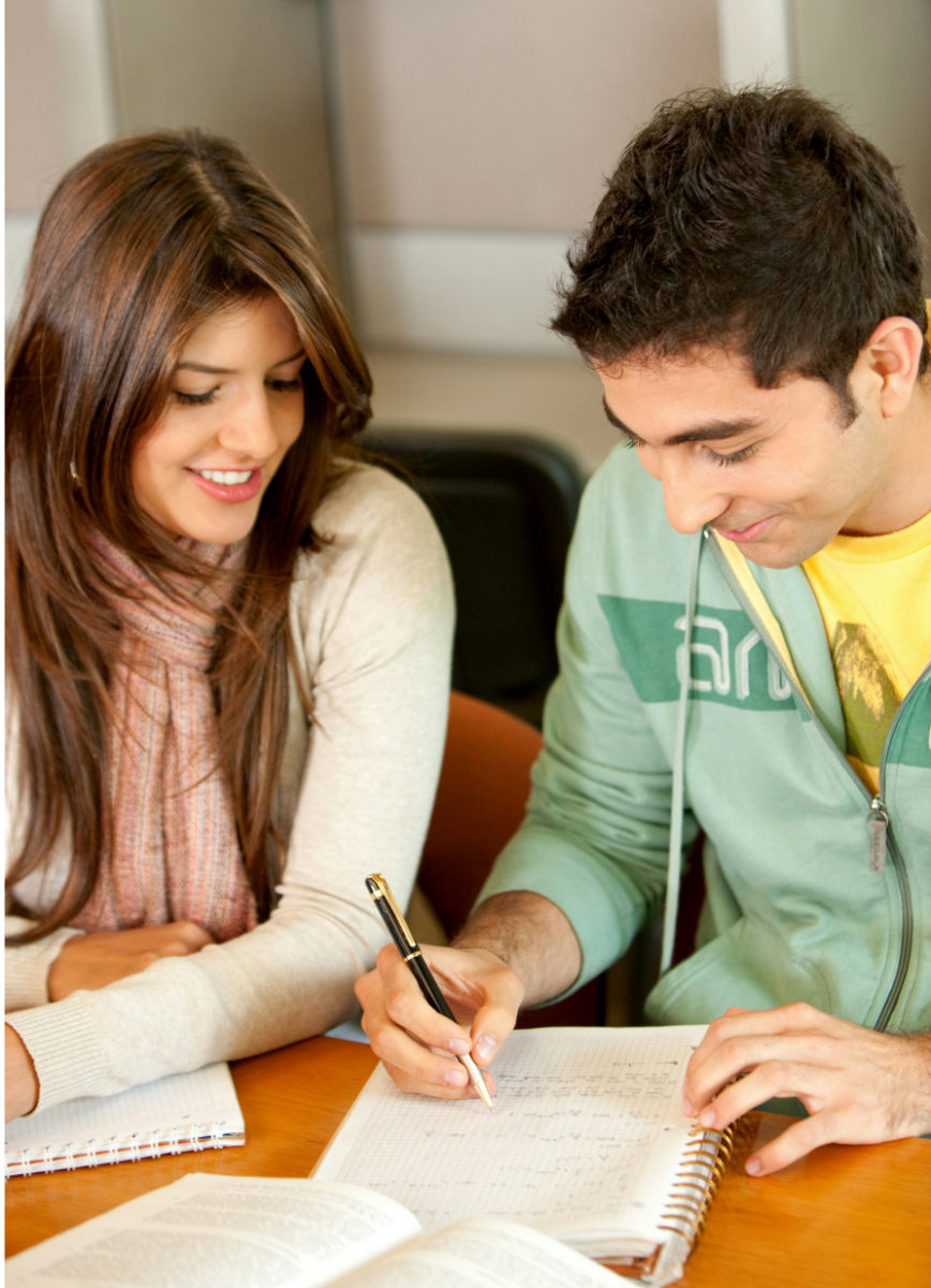 A male and female student work together on a paper
