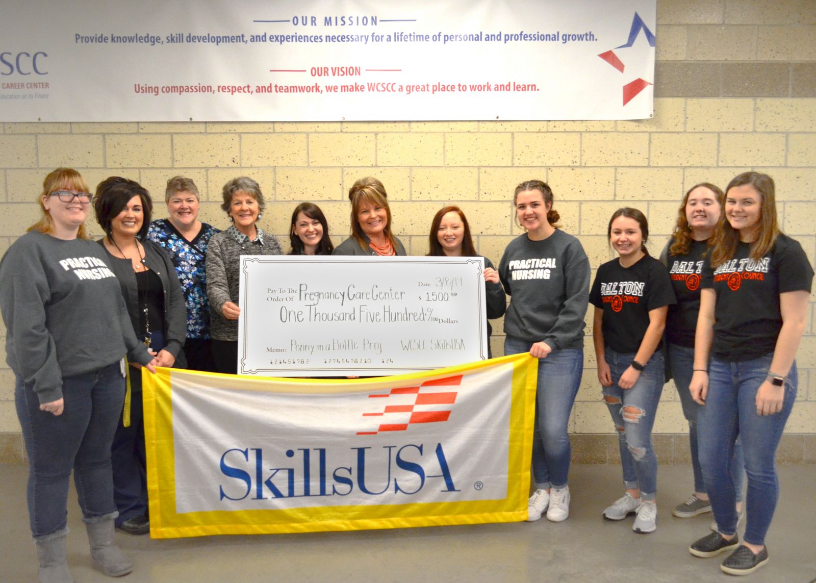 Nursing students present check to Pregnancy Care Center staff