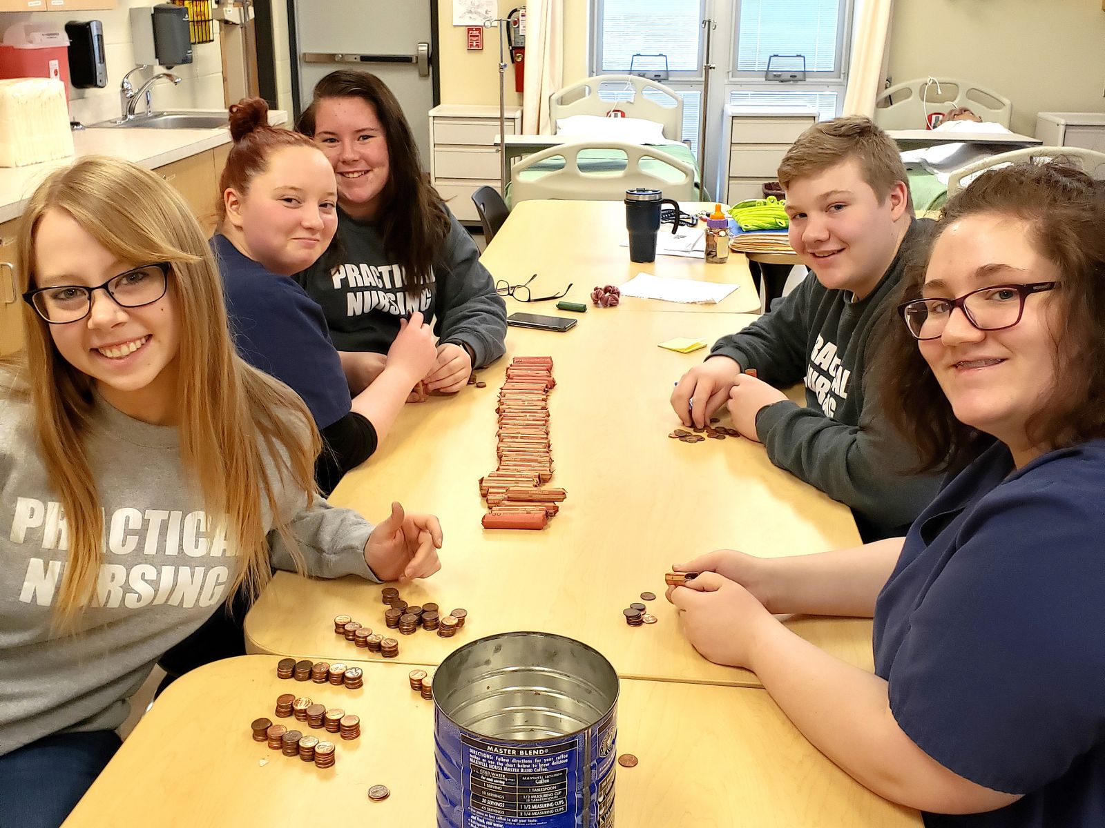 Practical Nursing students roll change collected for their fundraiser to benefit the Pregnancy Care Center