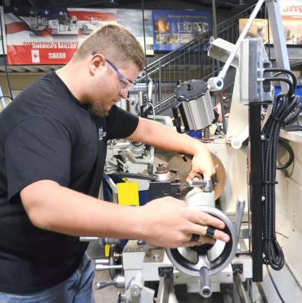 Machining Technologies student operates a manual lathe
