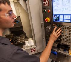 Image of student programming a CNC machine