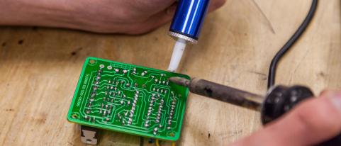 Image of soldering iron on circuit board 