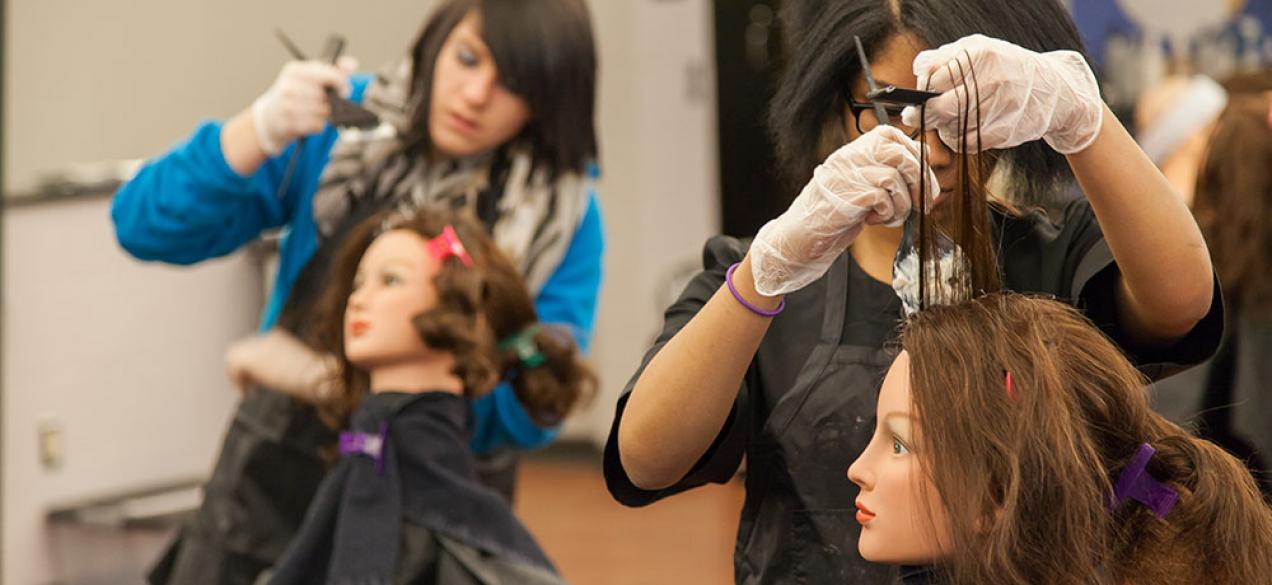 Image of student coloring mannequin's hair