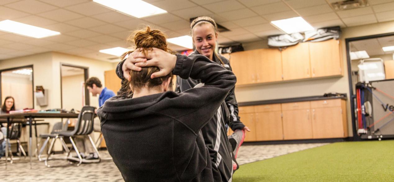 Image of student working with client on exercises