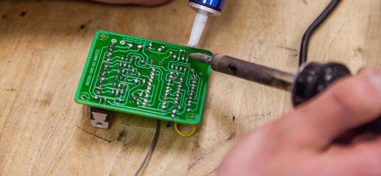 Image of soldering iron on circuit board 