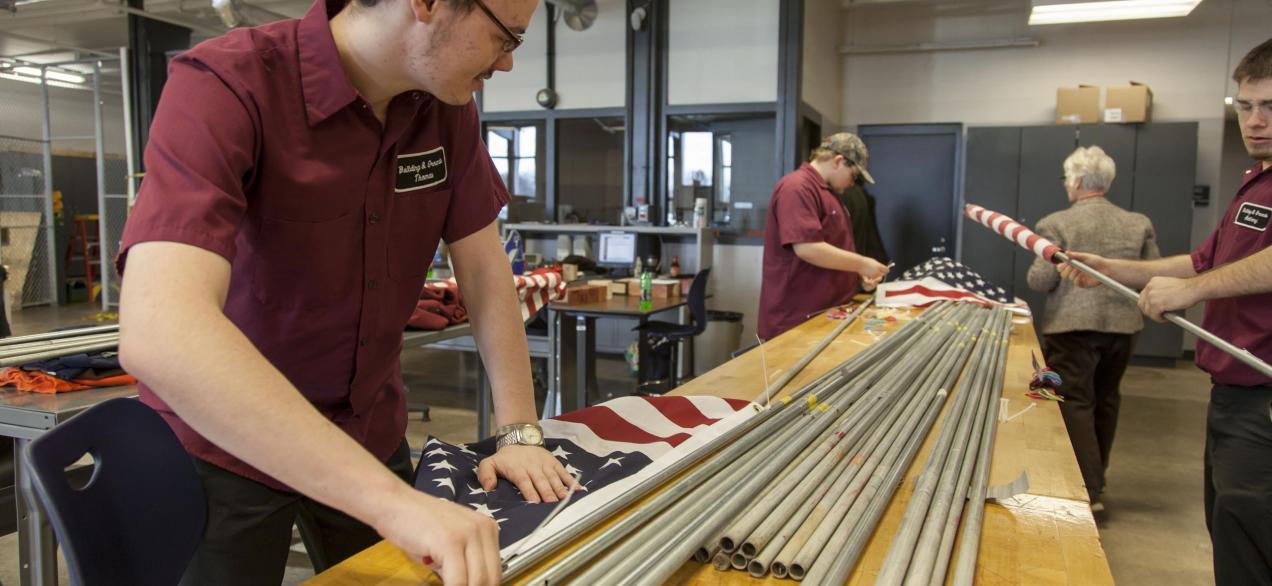 Image of students working with putting out American flags