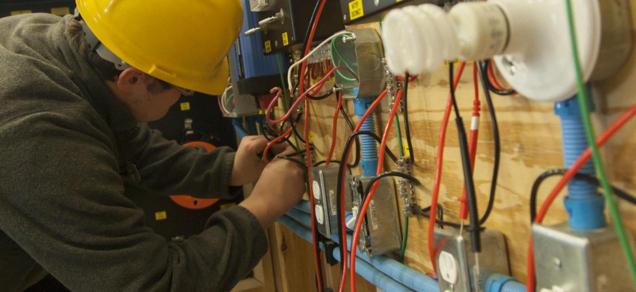 Image of student working on wiring project involving wind energy