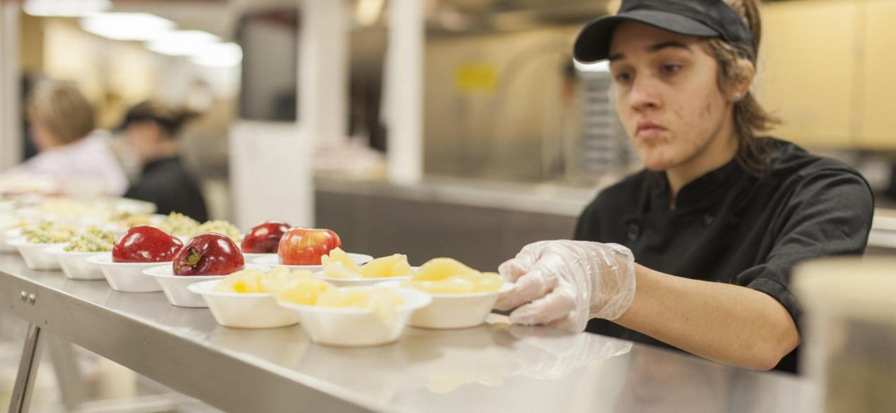 Image of student serving pears