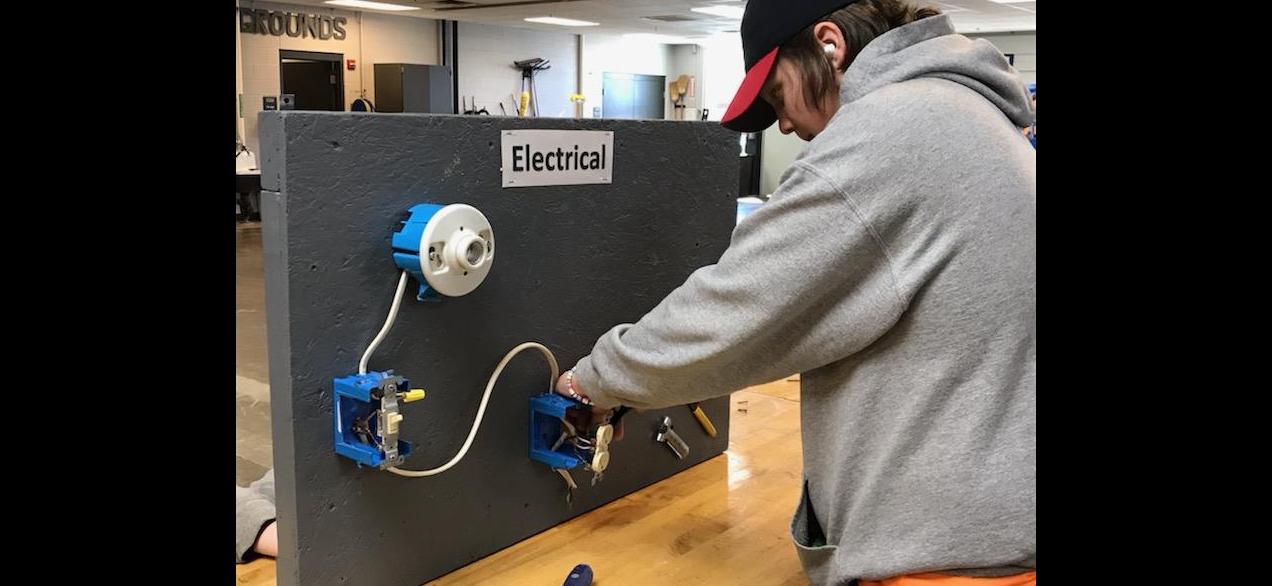 Image of student learning electrical wiring techniques