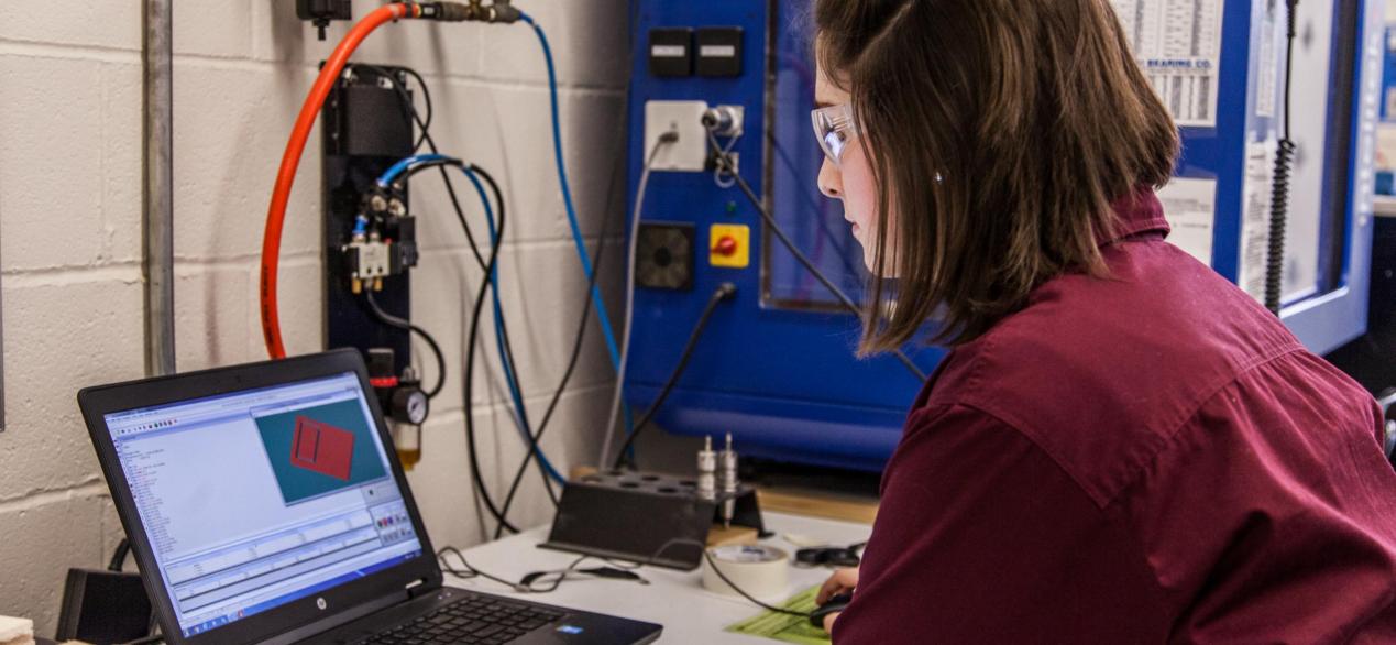 Image of female student working on designing a project on a labtop