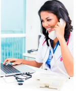 image of a young woman in a medical office on the phone and computer