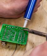 Image of soldering iron on circuit board 