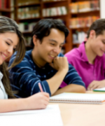 3 adult students study at a table