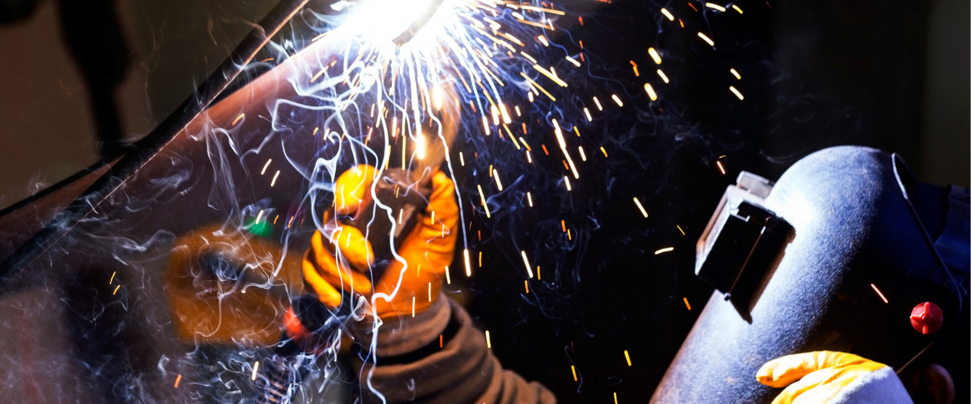 A welder welding above his head