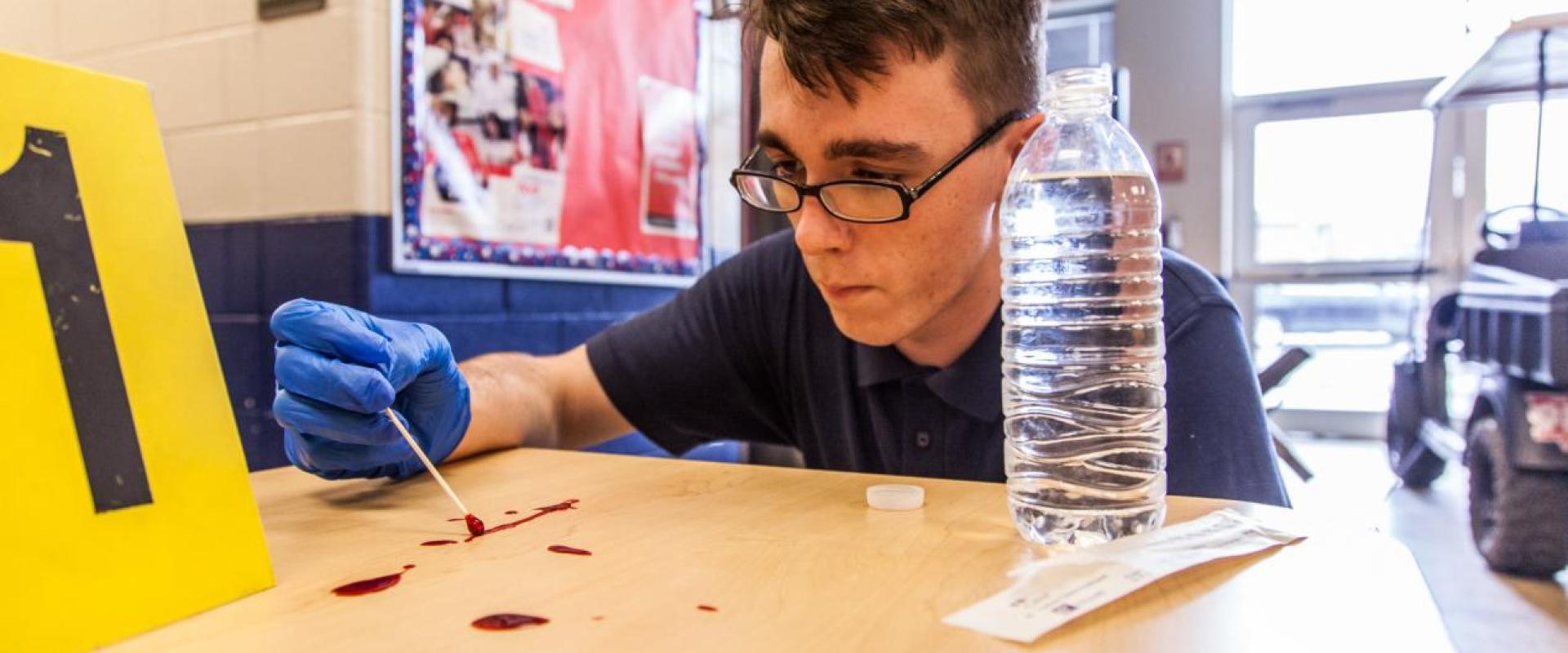 A student collecting a blood sample