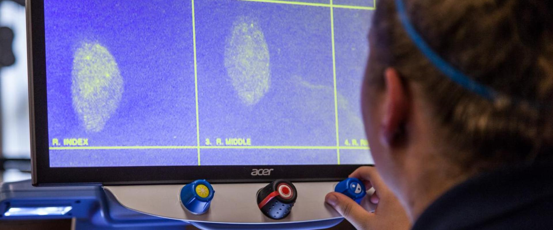A student examining fingerprints