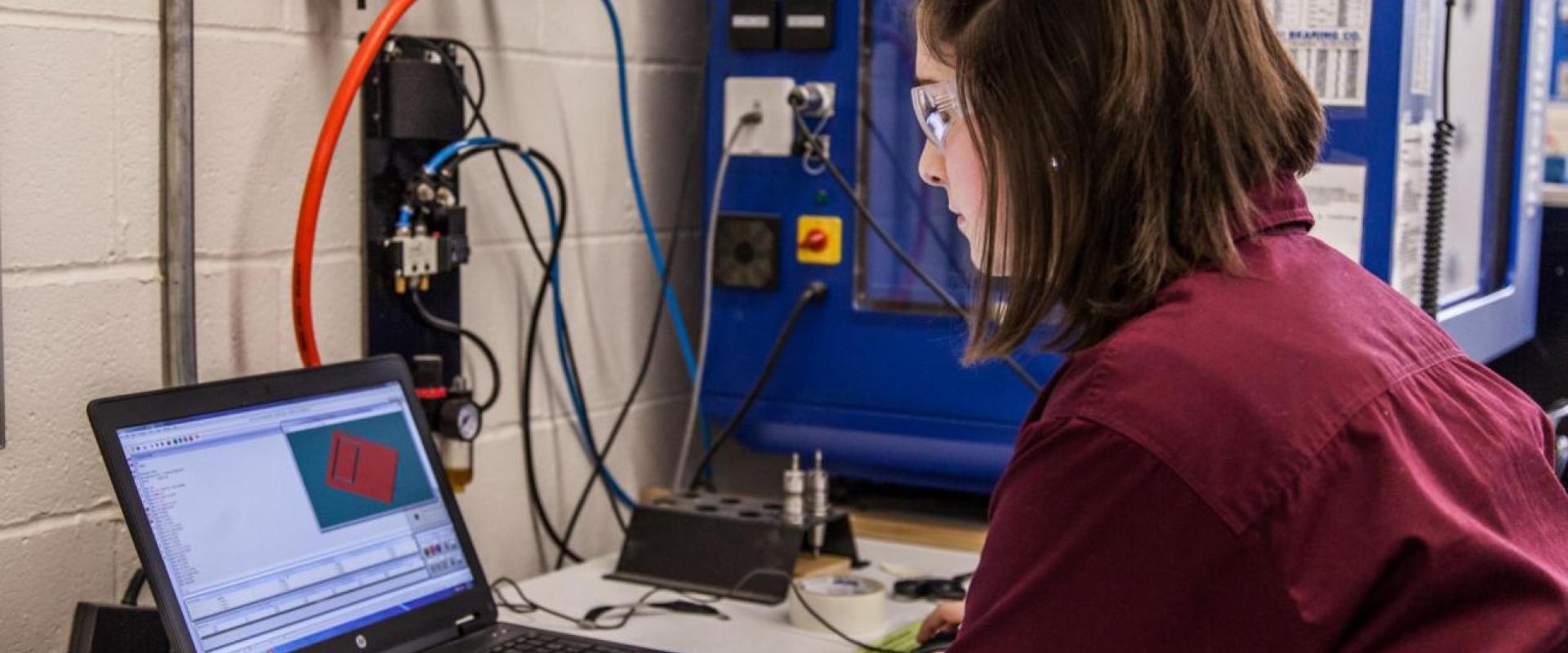 A girl reviewing a CAD software