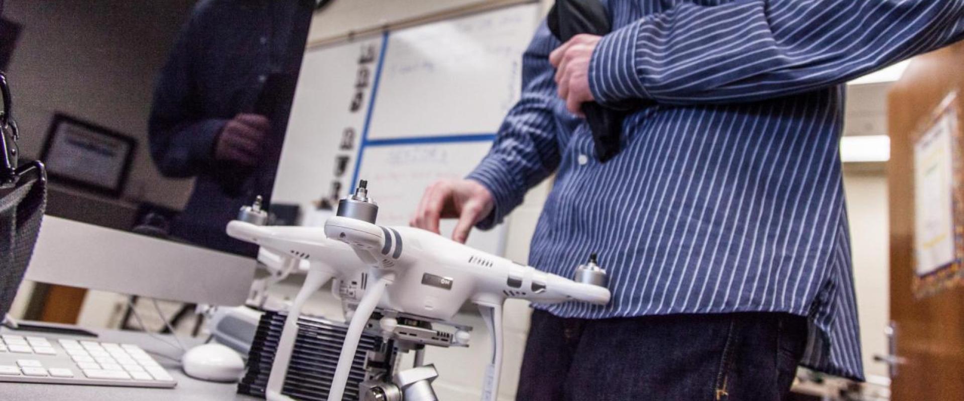 a man standing in front of a drone