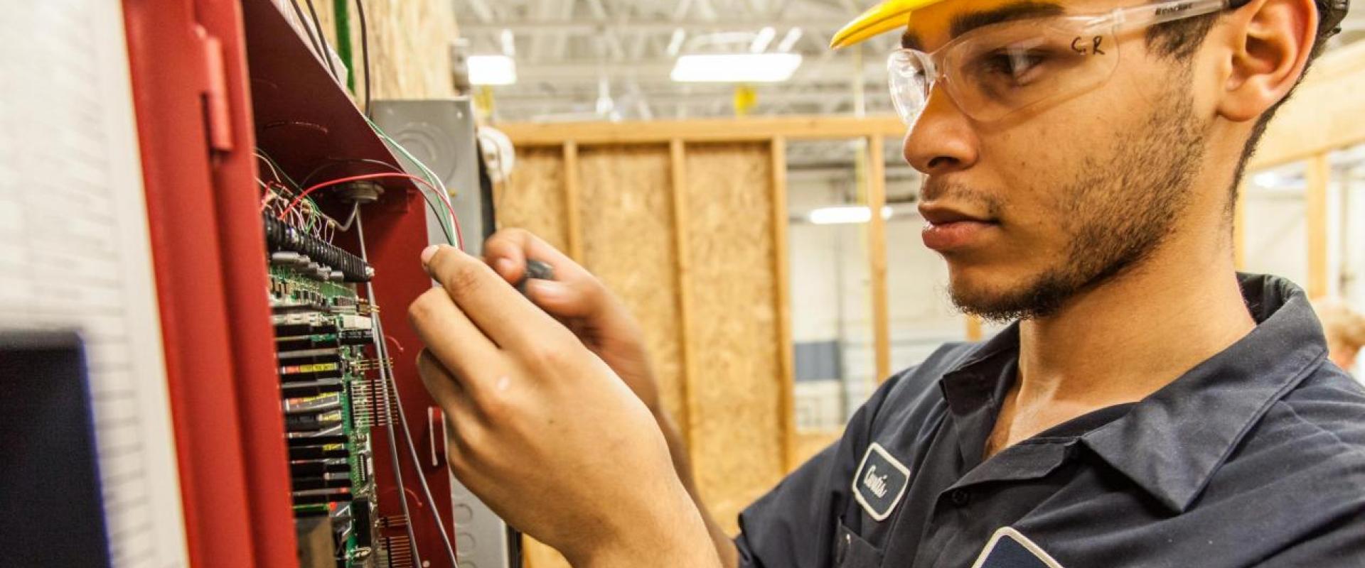 A male working at an electrical box