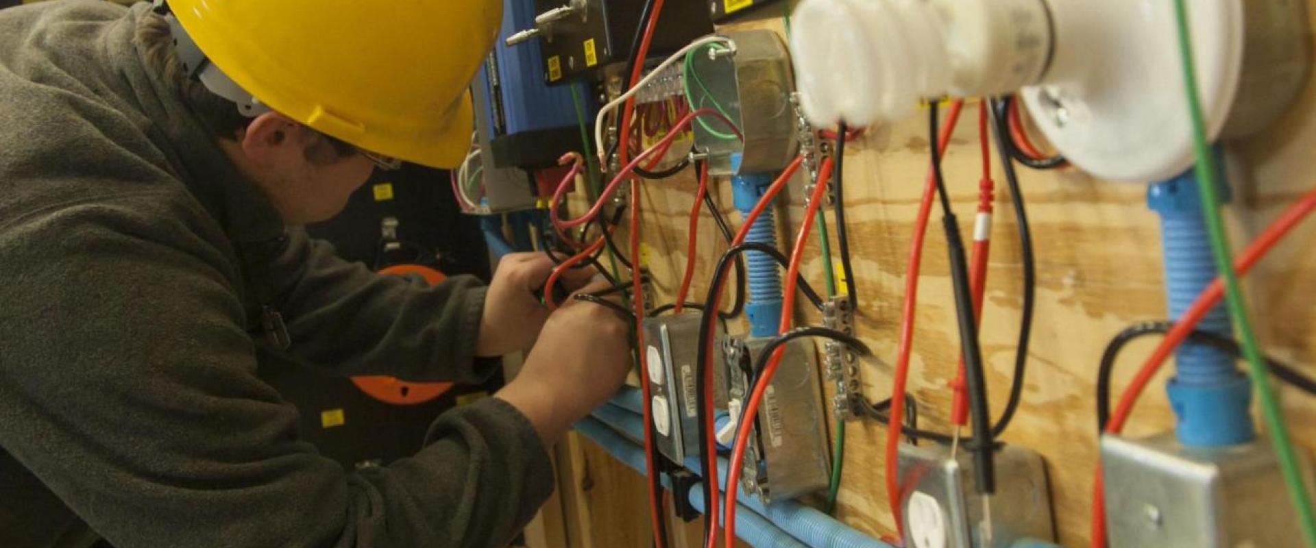An individual working at an electrical box