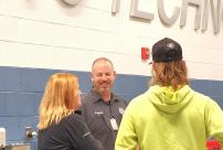 Instructor speaking with student and parent