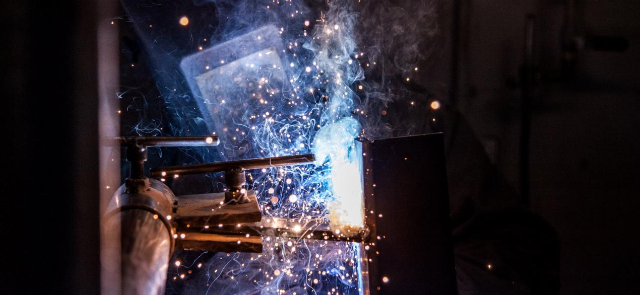 Image of student welding in class