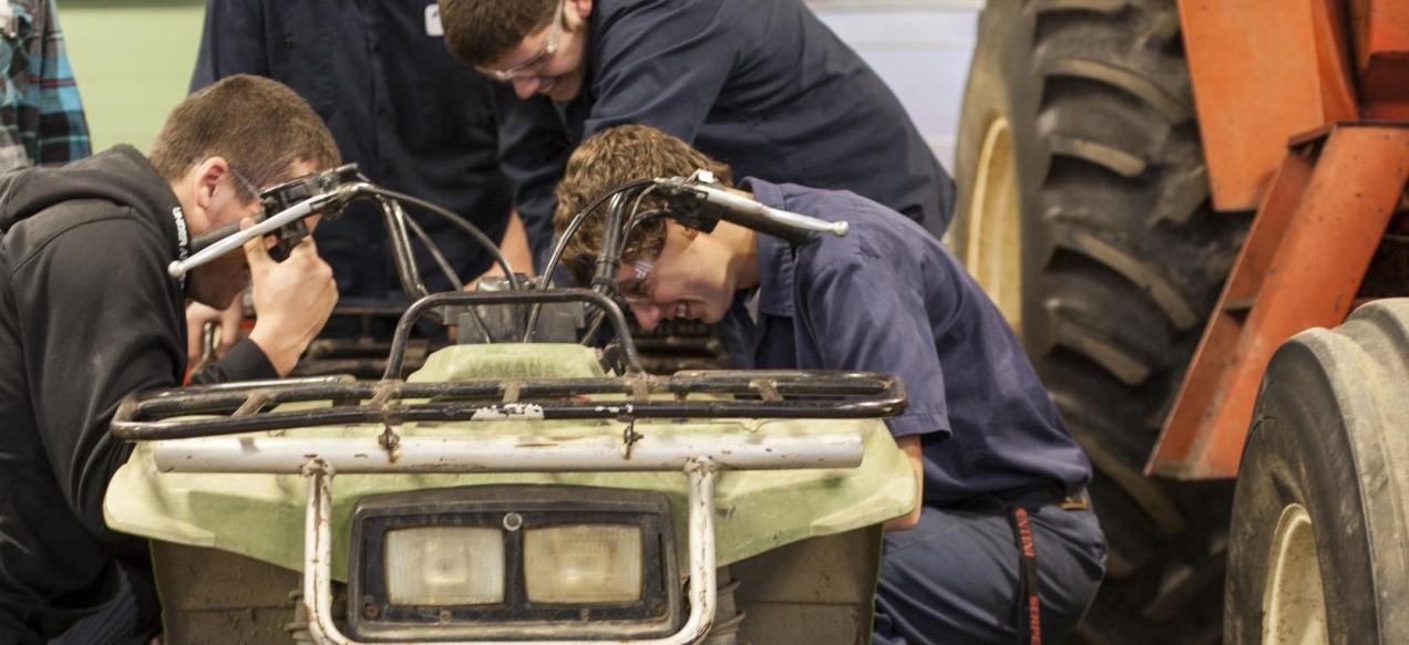 Image of students working on 4-wheeler