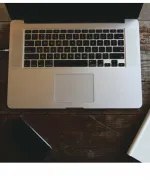 Macbook opened on a brown table. 