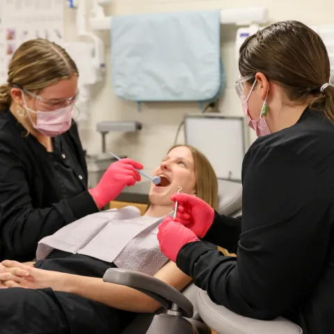 dental office person getting teeth cleaned