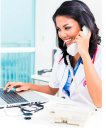 image of a young woman in a medical office on the phone and computer