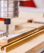 image of a drill press and wood